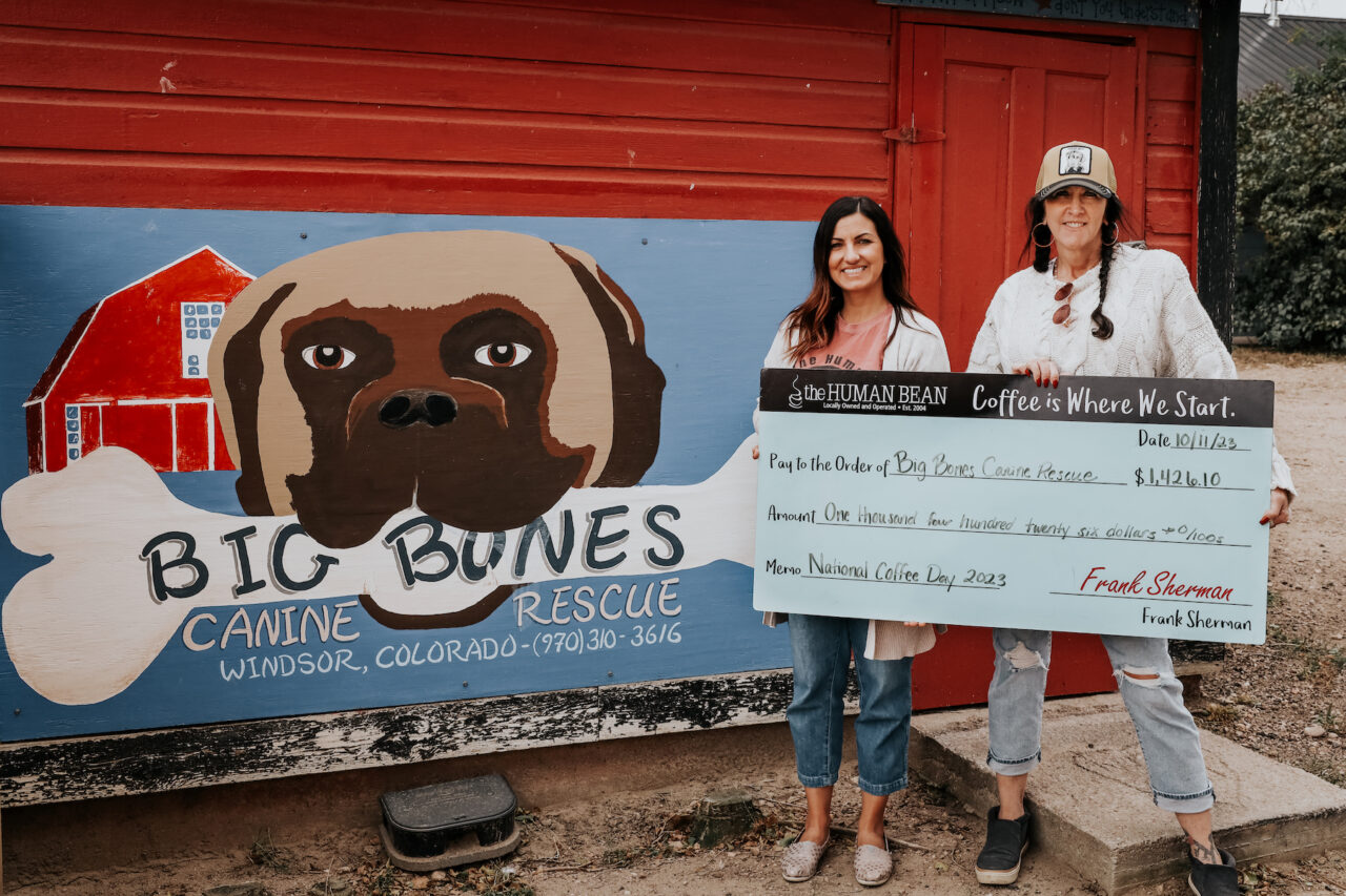 Human Bean presents a check to Big Bones Canine Rescue