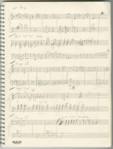 Notebook page with music composition hand-written in pencil in draft form over entire page.