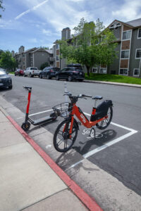 A Fort Collins Spin bike and scooter parked in one of many designated locations around the city.