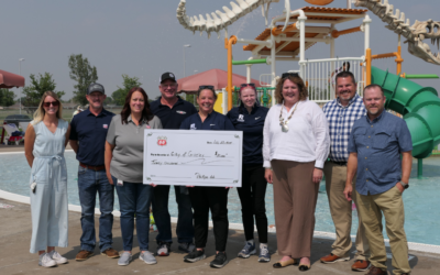 Kelly McClanahan, City of Greeley Recreation aquatics supervisor, holds a check for $20,000 at the Discovery Bay Waterpark in Greeley. Phillips 66 presented the check to the recreation division for swimming lessons and aquatics equipment and technology upgrades.