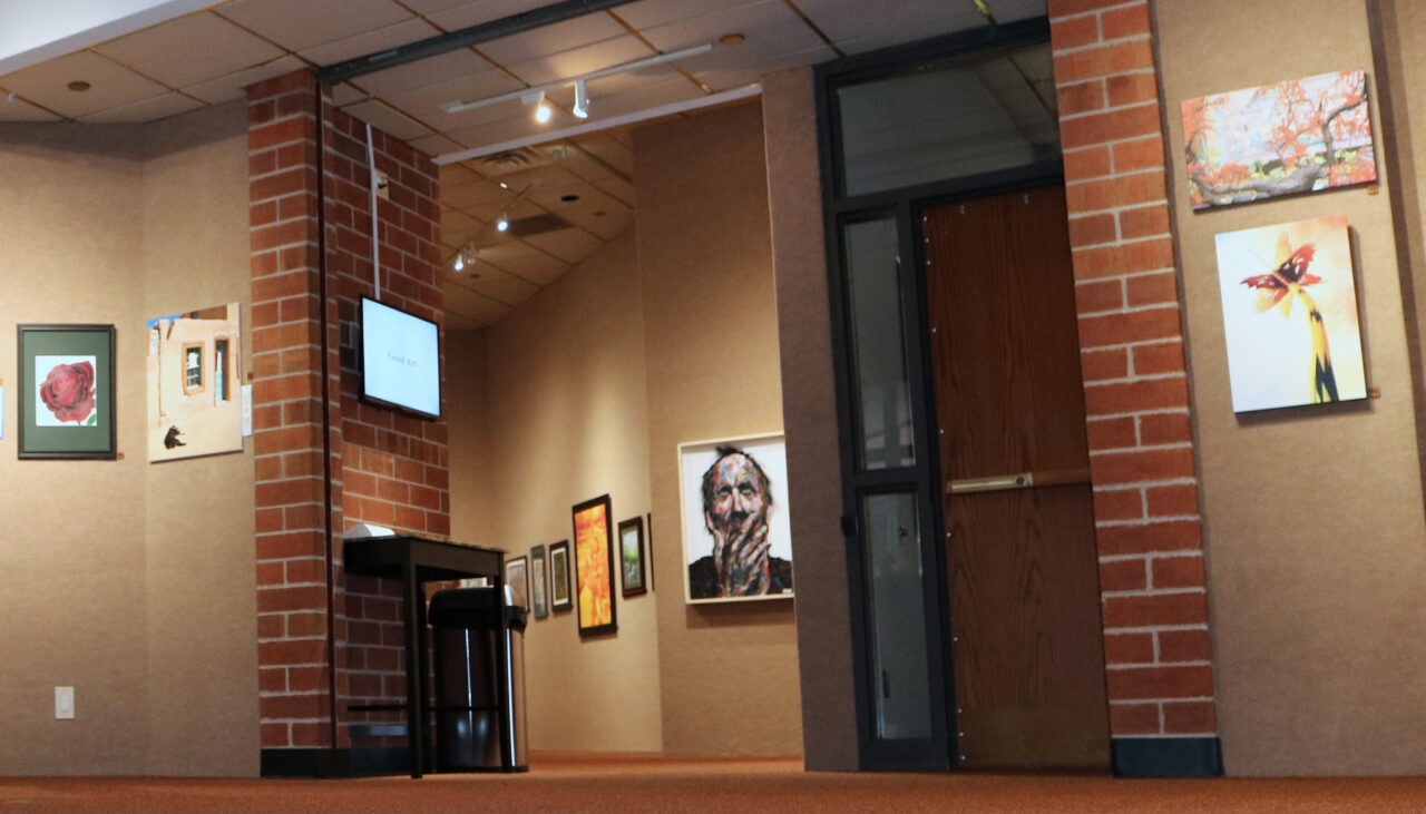 The entry to the Tointon Gallery in Greeley, CO, with artwork displayed on the walls.