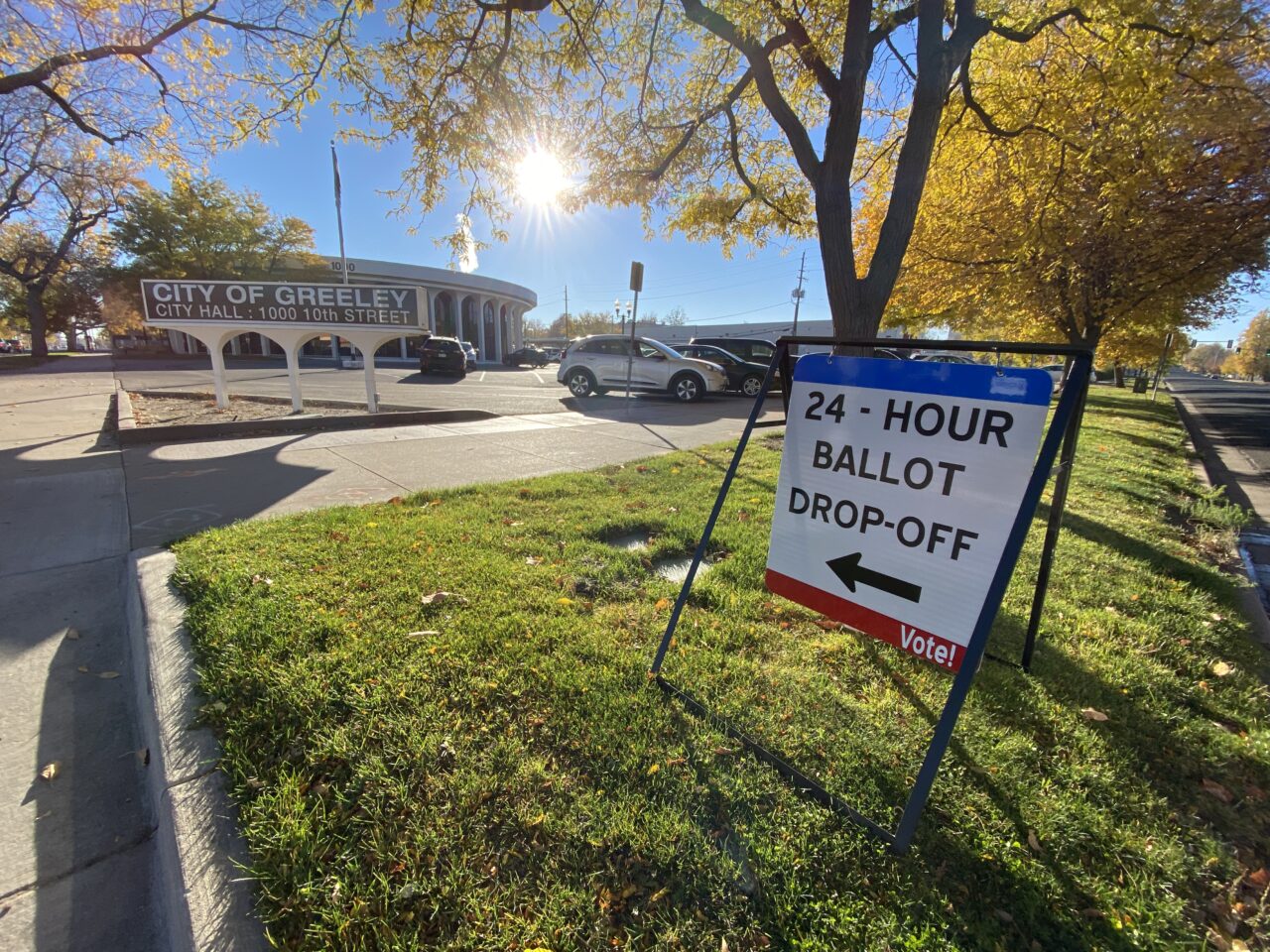 A red, white and blue sign outside Greeley City Hall that reads “24-Hour Ballot Drop-off. Vote!”