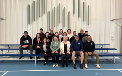 Employees from the City of Greeley’s Culture, Parks and Recreation Department and United Way pose for a photograph while seated on bleachers after the Weld County Recreation Scholarship event reception.